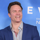 A photo shows Scott Porter at a red carpet event.